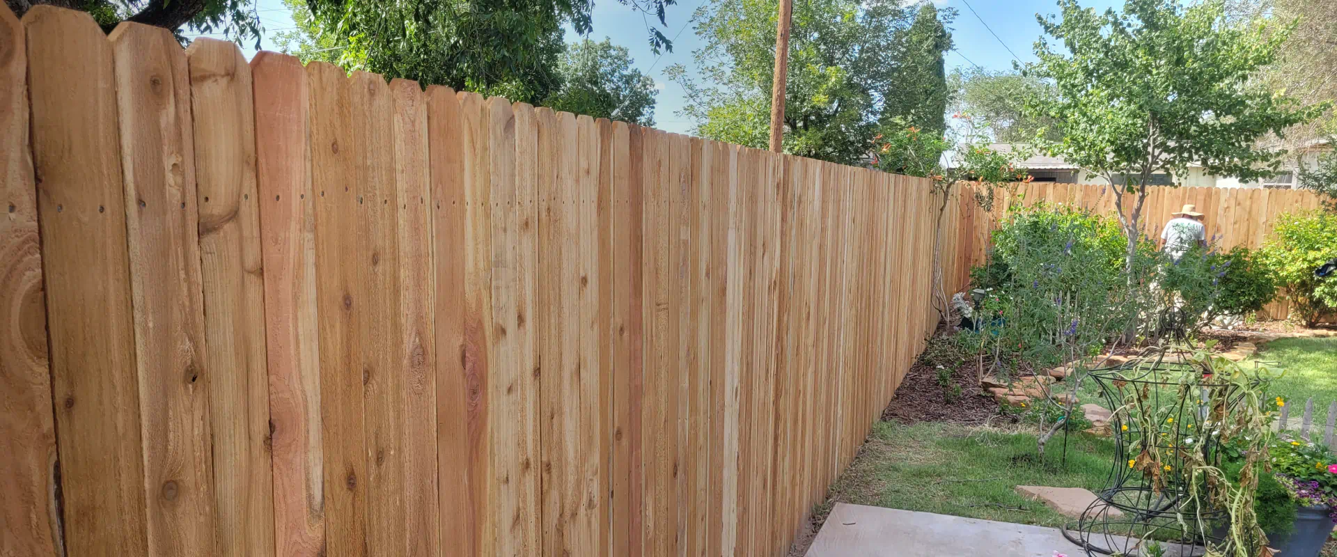 newly installed wooden fence in a house backyard